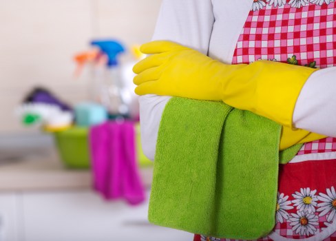 Cleaner preparing carpet cleaning equipment with safety precautions